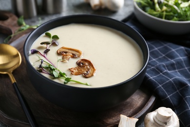 Delicious cream soup with mushrooms on table, closeup