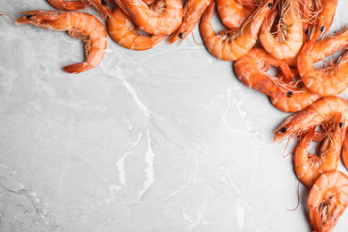 Photo of Delicious cooked shrimps on grey marble table, flat lay. Space for text