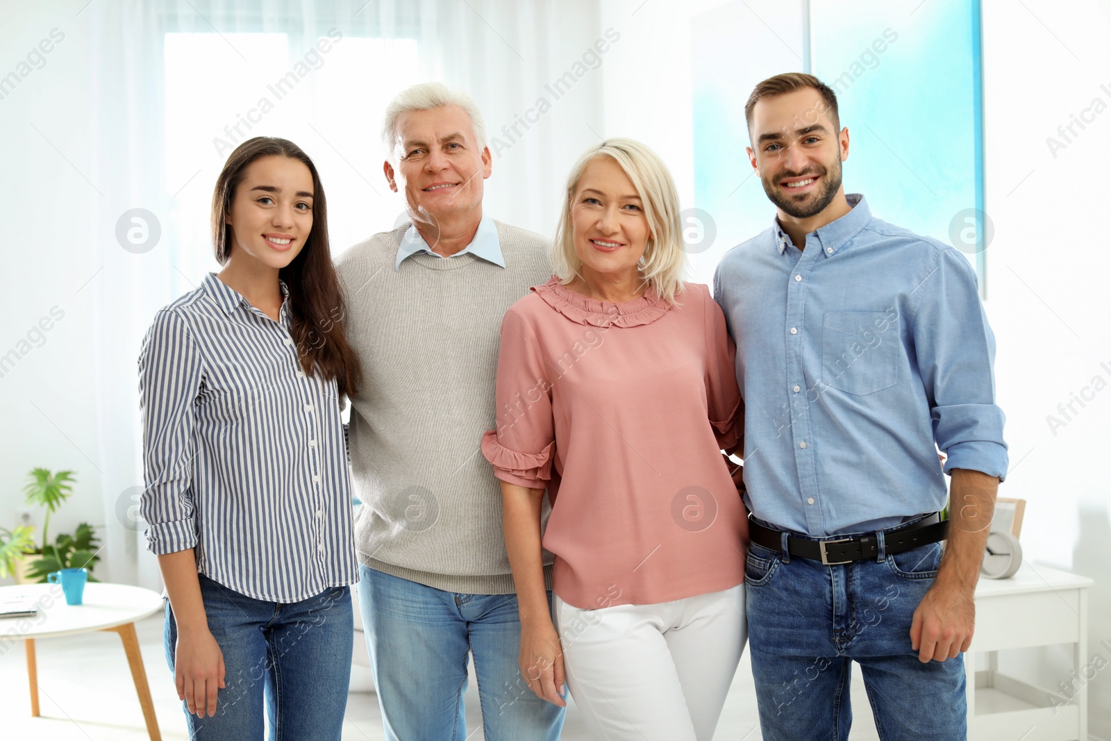 Photo of Portrait of happy family at home. Reunion of generations