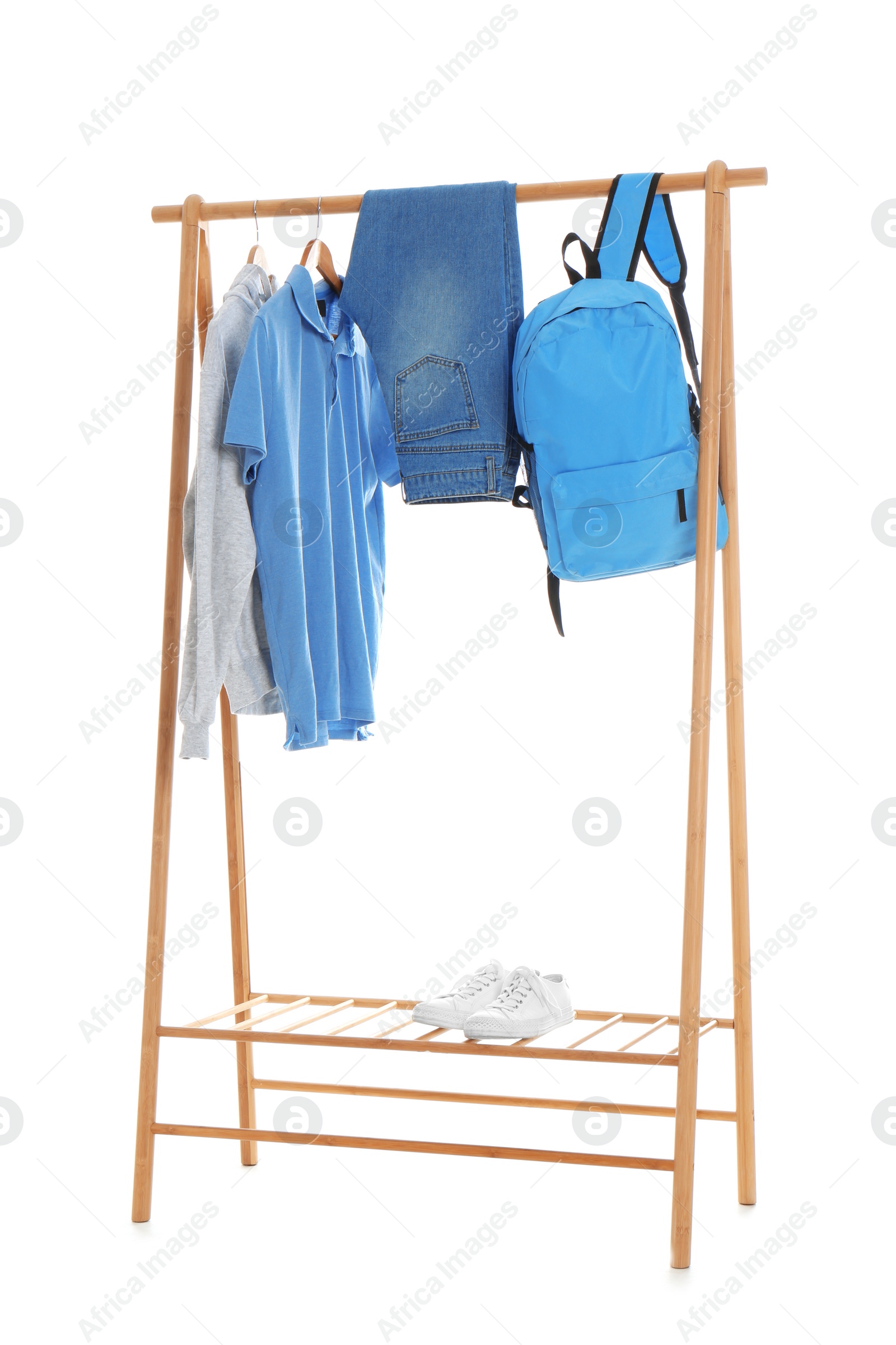 Photo of New wardrobe rack with stylish man's clothes and shoes on white background