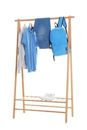 Photo of New wardrobe rack with stylish man's clothes and shoes on white background