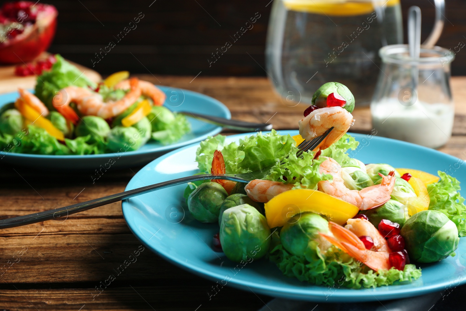 Photo of Tasty salad with Brussels sprouts served on wooden table