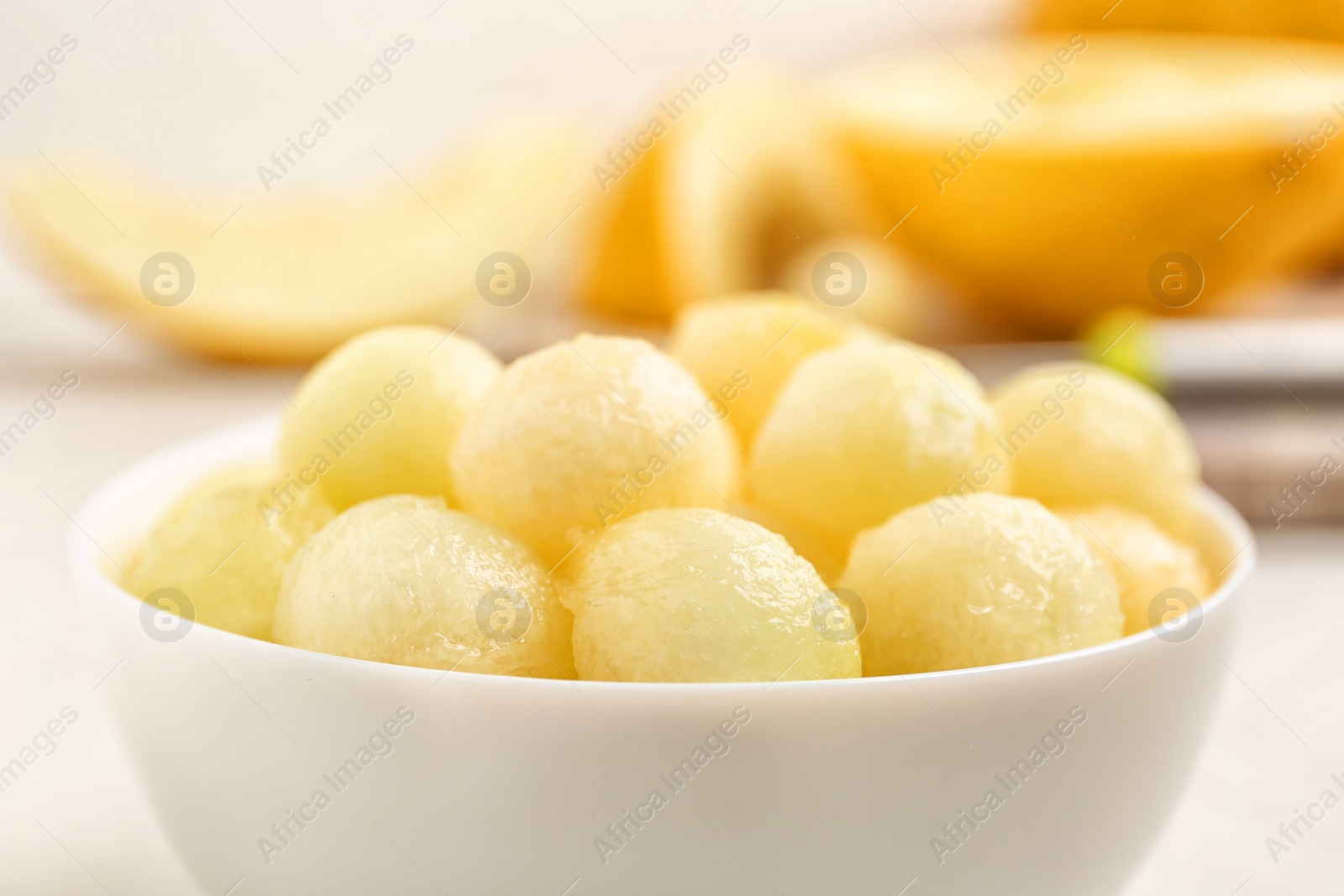 Photo of Bowl of melon balls on table, closeup