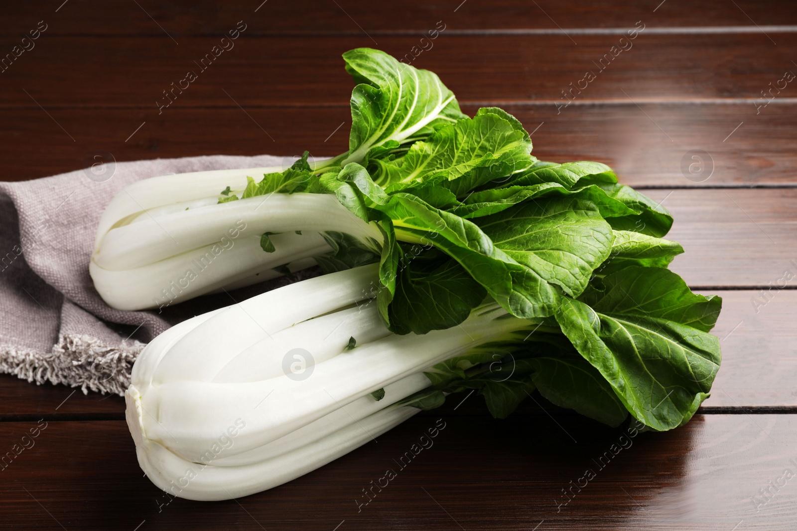 Photo of Fresh green pak choy cabbages on wooden table