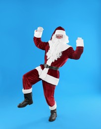 Photo of Full length portrait of Santa Claus on light blue background