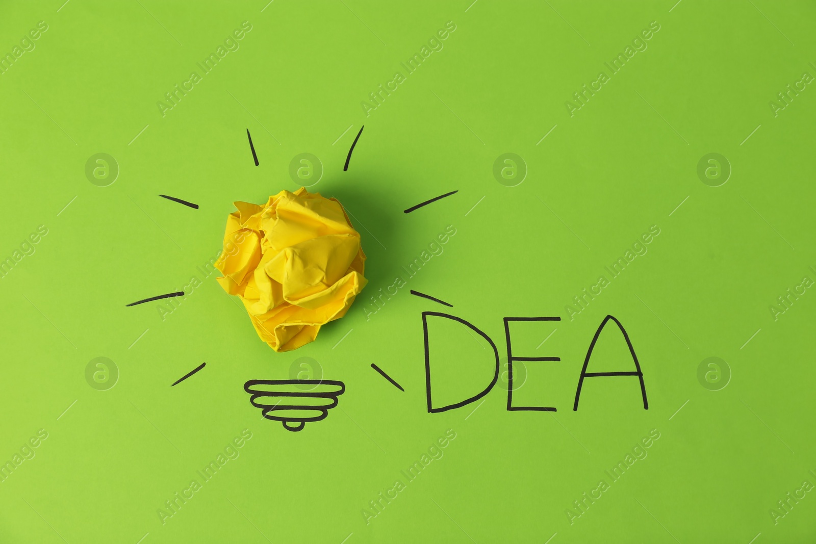 Photo of Composition with crumpled paper ball, drawing of lamp bulb and word IDEA on color background. Creative concept