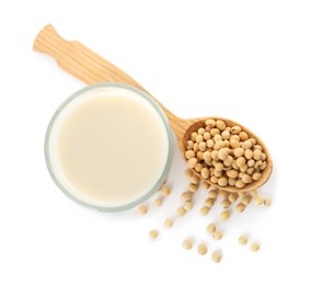 Photo of Glass of fresh soy milk and spoon with beans on white background, top view