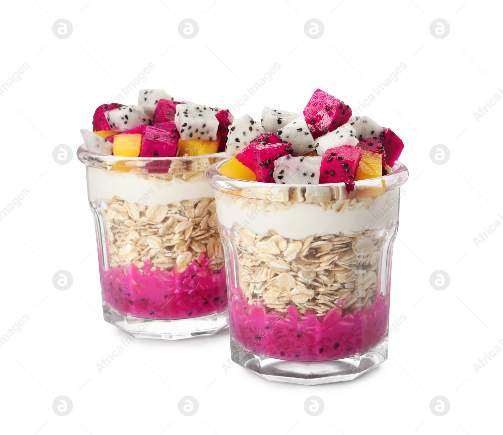 Photo of Glasses of granola with pitahaya, yogurt and mango on white background