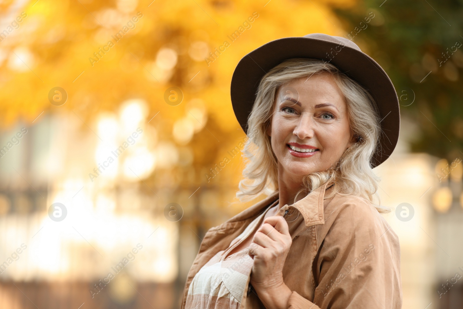 Photo of Portrait of happy mature woman with hat outdoors