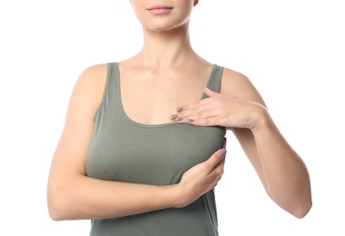 Woman checking her breast on white background, closeup