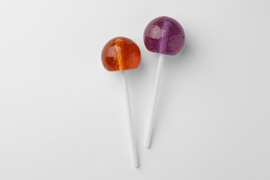 Tasty lollipops on white background, flat lay