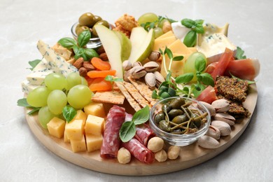 Photo of Different tasty appetizers on light table, closeup
