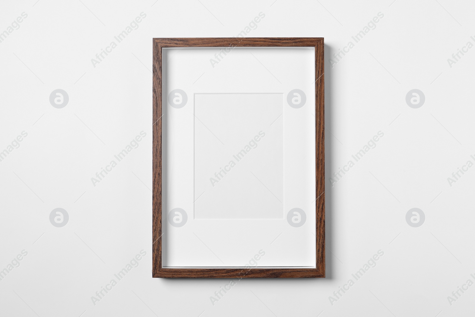 Photo of Empty wooden frame on white background. Mockup for design