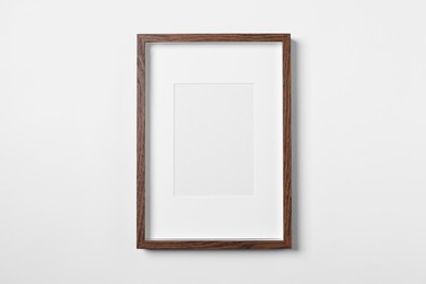 Photo of Empty wooden frame on white background. Mockup for design