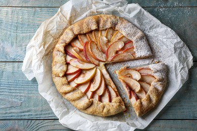 Photo of Delicious apple galette on wooden table, top view