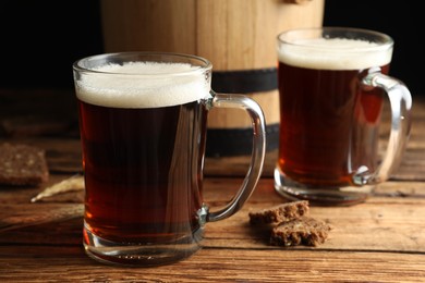 Photo of Delicious kvass, bread and spikes on wooden table