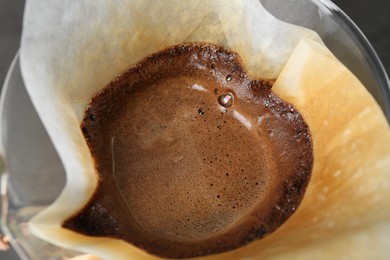 Paper filter with aromatic drip coffee, closeup