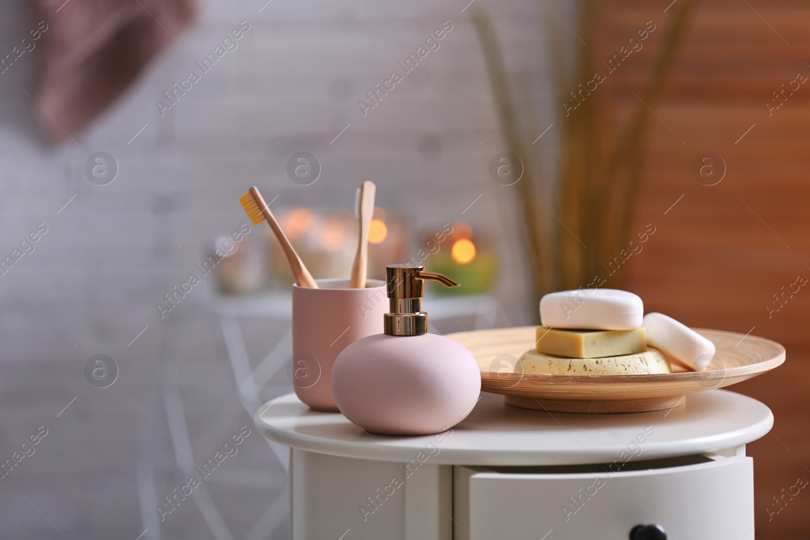 Photo of Aromatic soap and shampoo on table against blurred background. Space for text