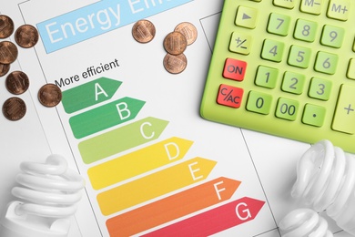 Photo of Flat lay composition with energy efficiency rating chart and calculator on white background