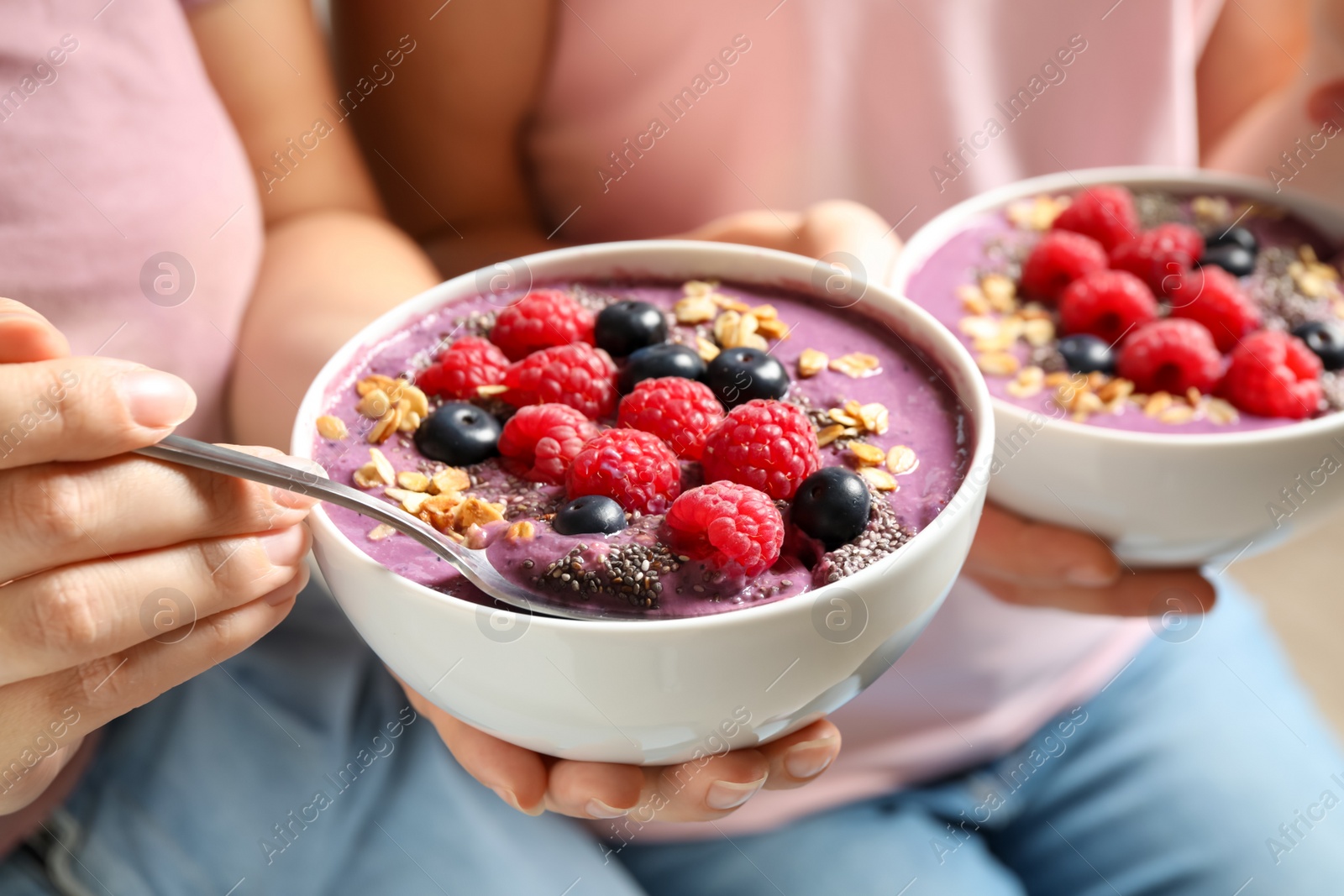 Photo of Women with tasty natural acai smoothie, closeup