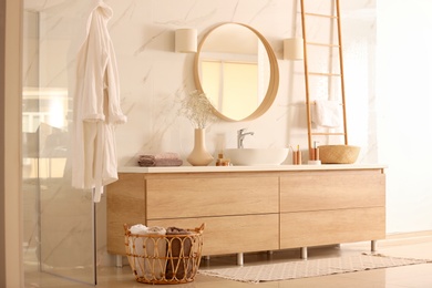 Modern bathroom interior with stylish mirror and vessel sink