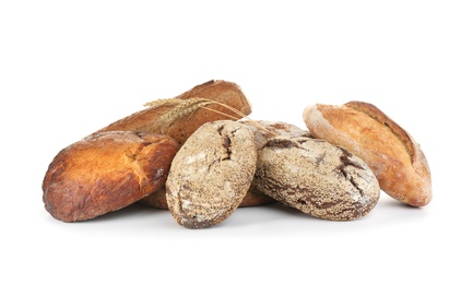 Loaves of delicious fresh bread on white background