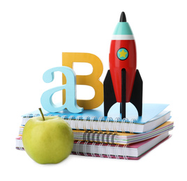 Photo of Bright toy rocket and school supplies on white background