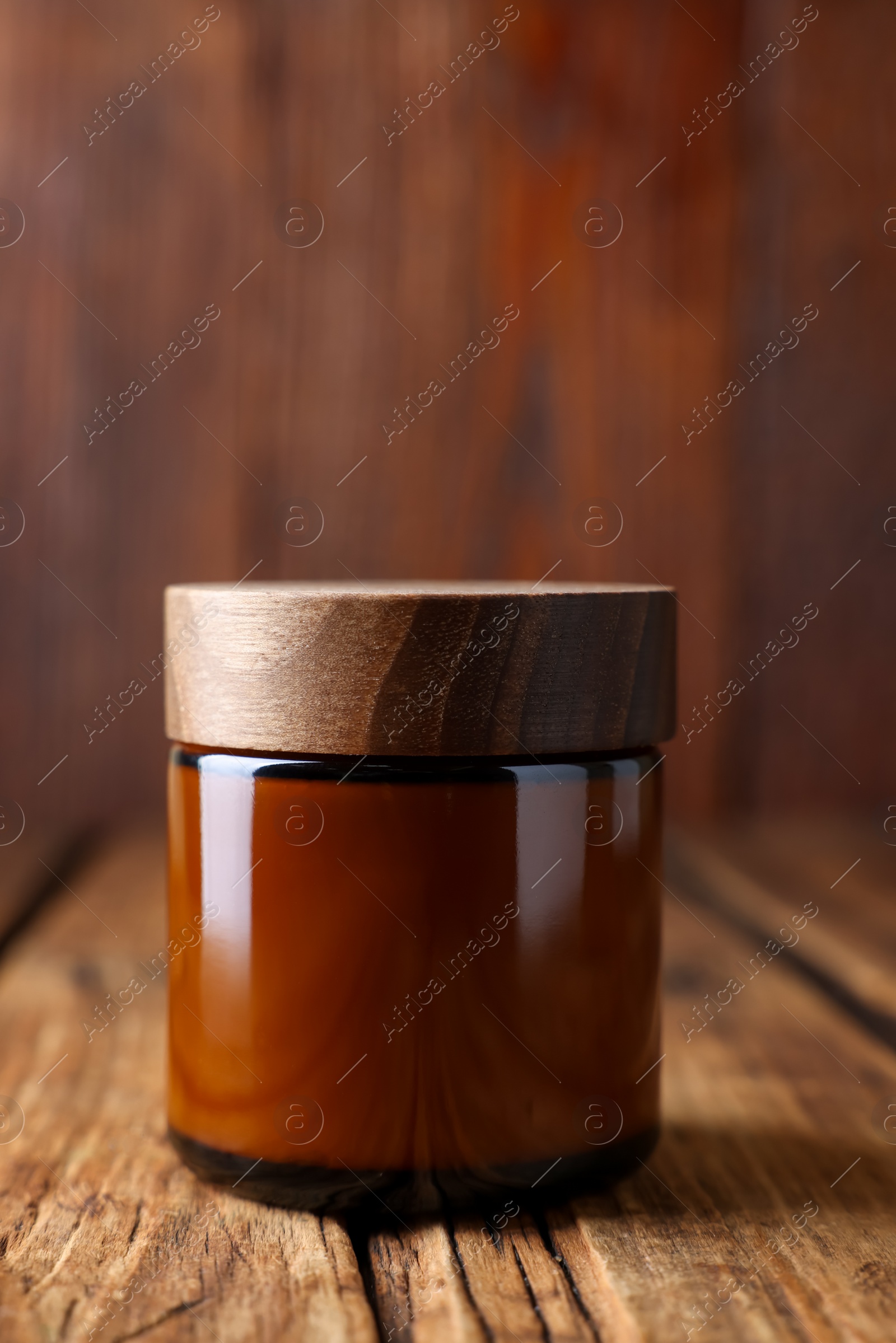 Photo of Jar of luxury cream on wooden table, closeup