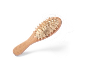 Photo of Brush with lost hair in air on white background