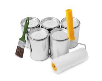 Cans of paints, brush and roller on white background