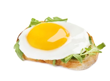 Slice of bread with fried egg and arugula on white background