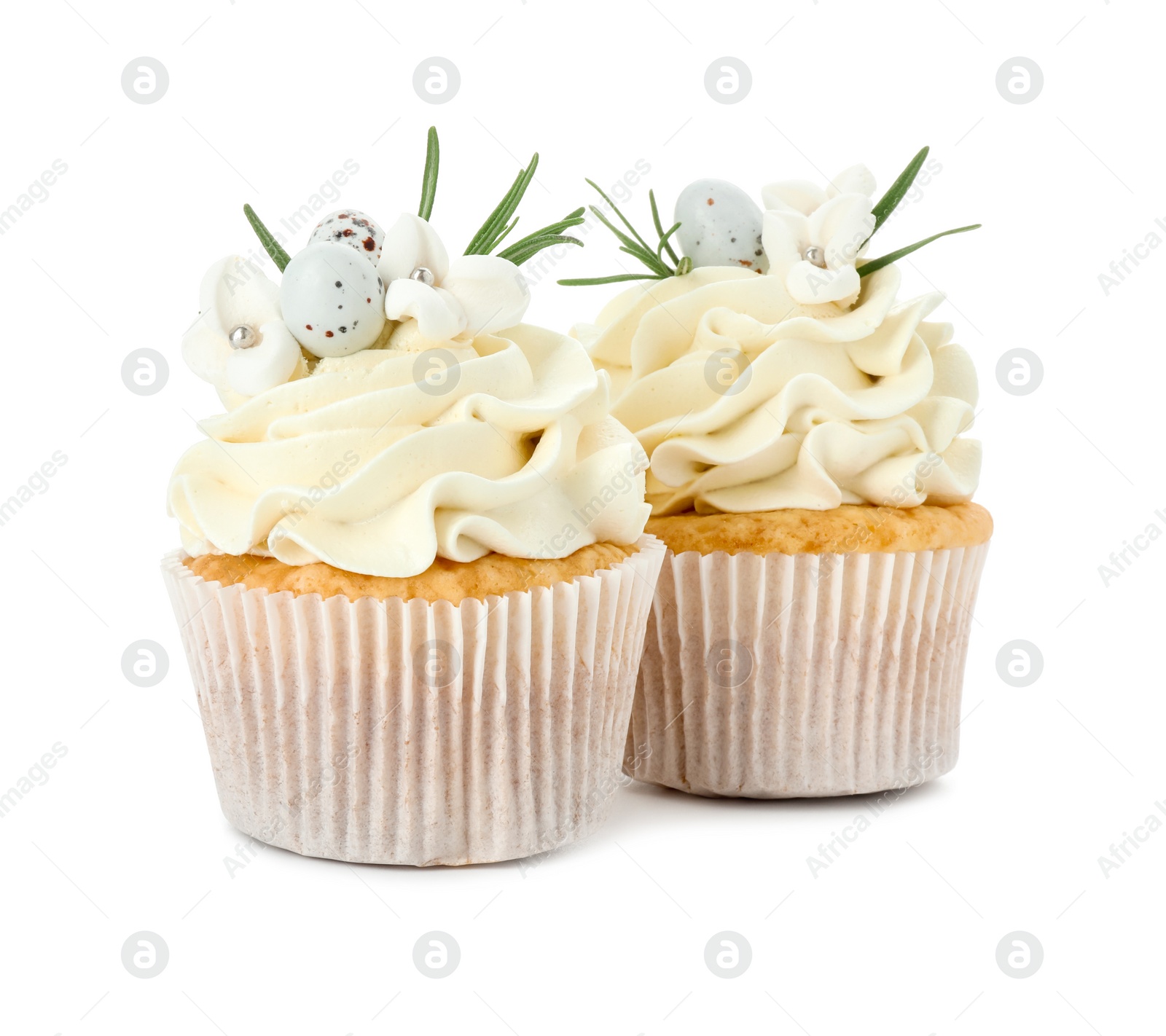 Photo of Tasty Easter cupcakes with vanilla cream isolated on white