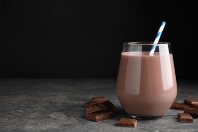 Photo of Delicious chocolate milk on grey table. Space for text