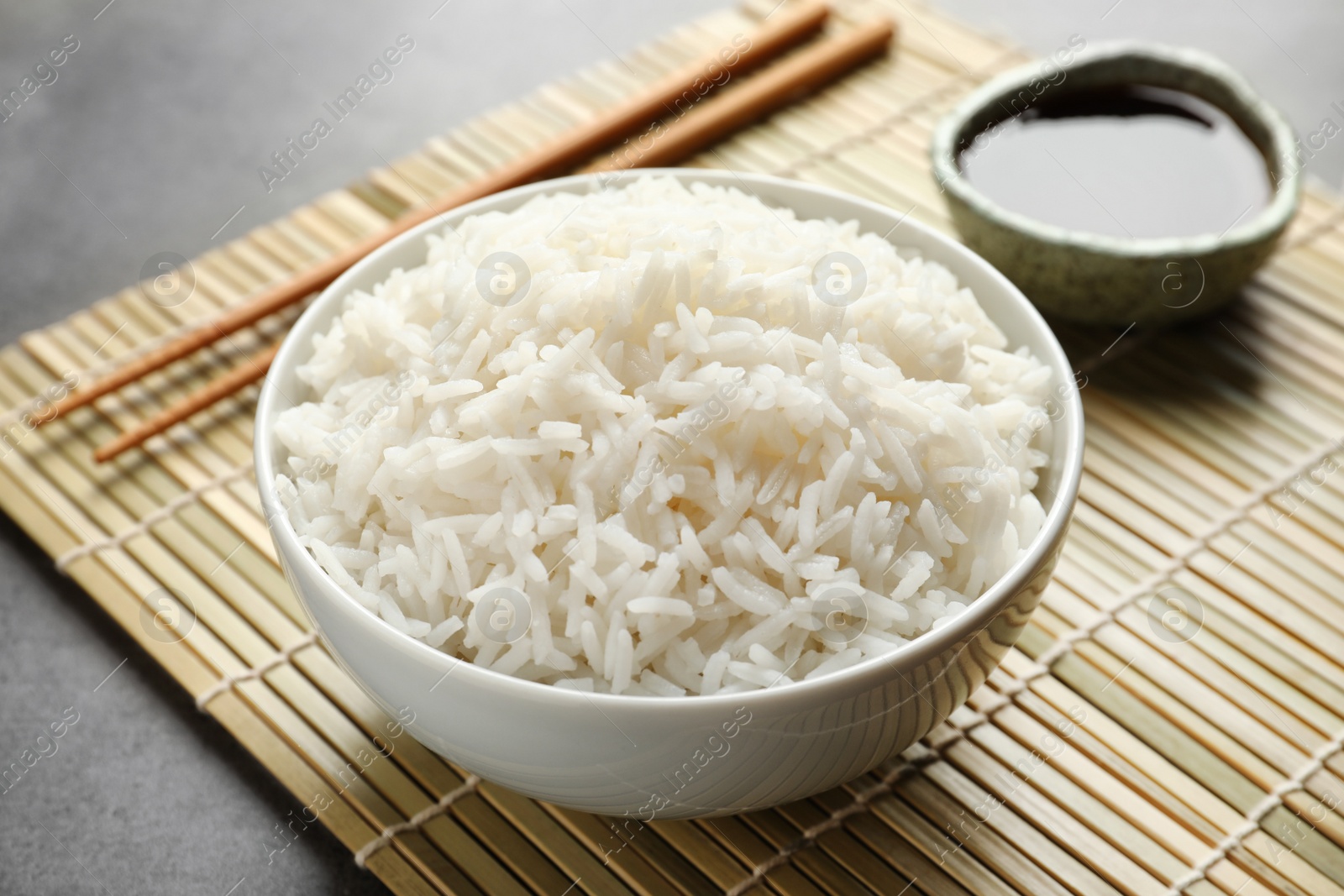 Photo of Bowl of tasty cooked rice served on table
