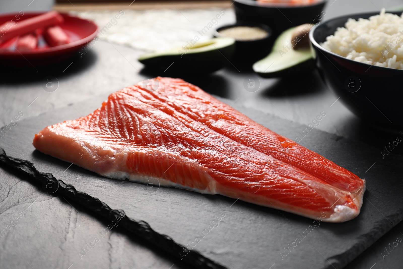 Photo of Fresh salmon for sushi on dark table, closeup