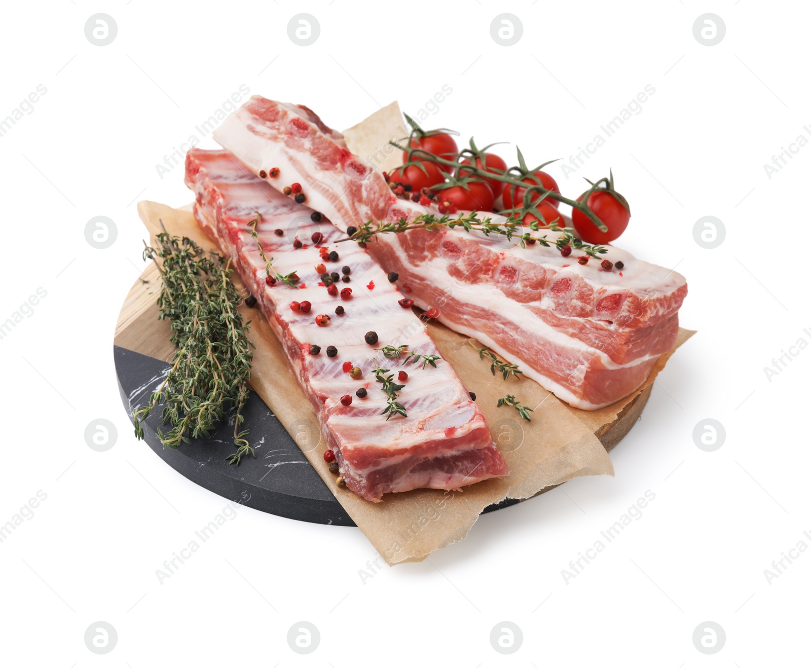 Photo of Raw pork ribs with spices and tomatoes isolated on white