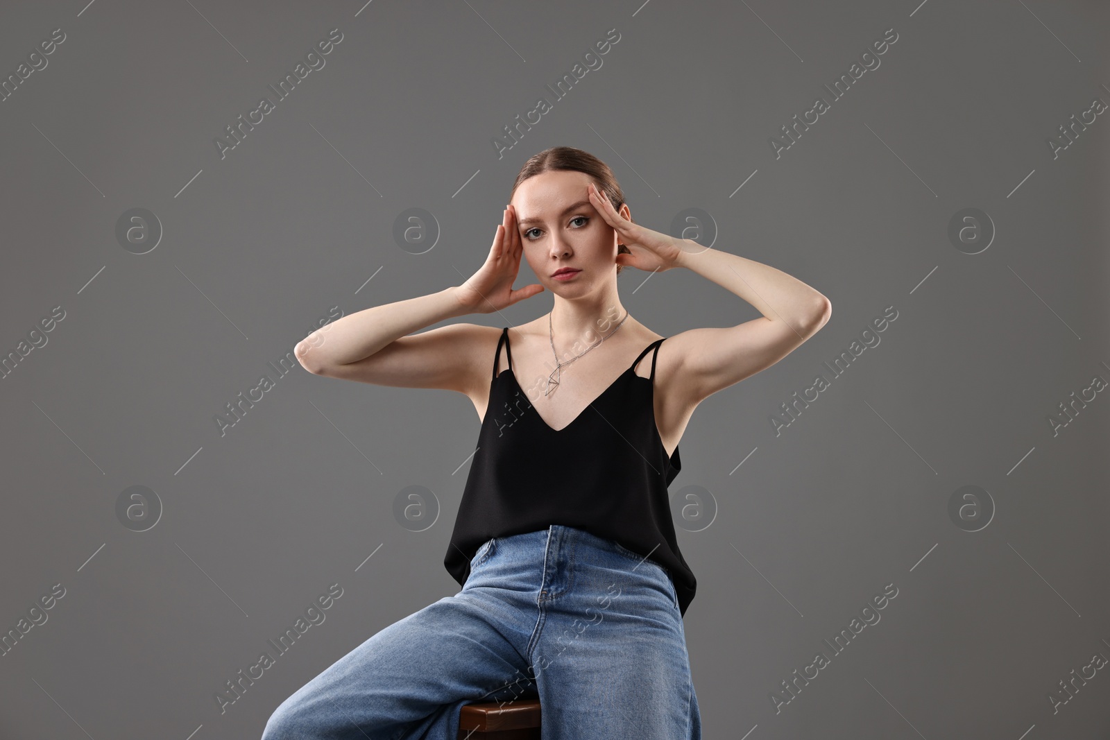 Photo of Fashionable portrait of beautiful young woman on grey background