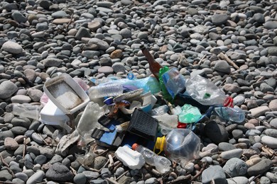 Photo of Pile of garbage on stones outdoors. Environmental Pollution concept