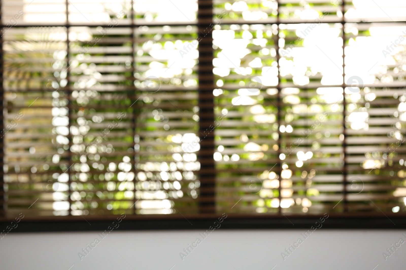 Photo of Blurred view through window on garden in morning