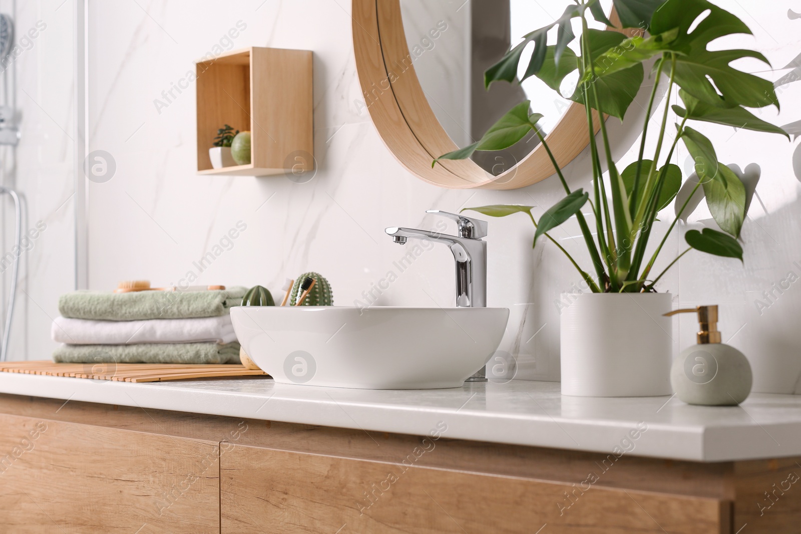 Photo of Stylish vessel sink on light countertop in modern bathroom