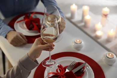 Couple having romantic dinner at home, closeup