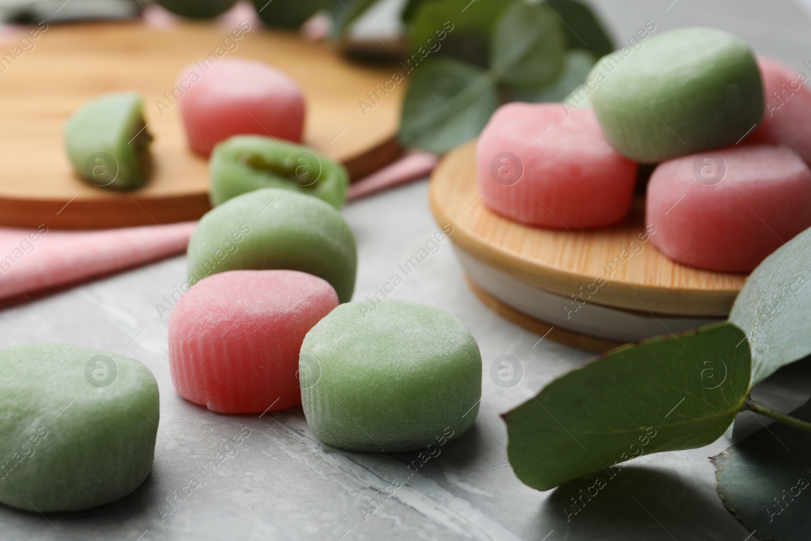 Photo of Many different delicious mochi on grey table. Traditional Japanese dessert