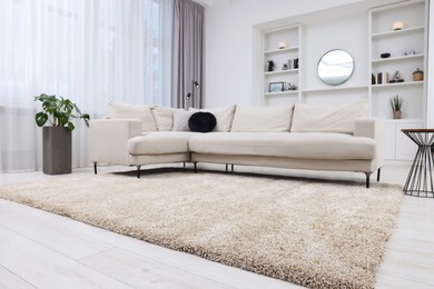 Photo of Fluffy carpet and stylish furniture on floor indoors