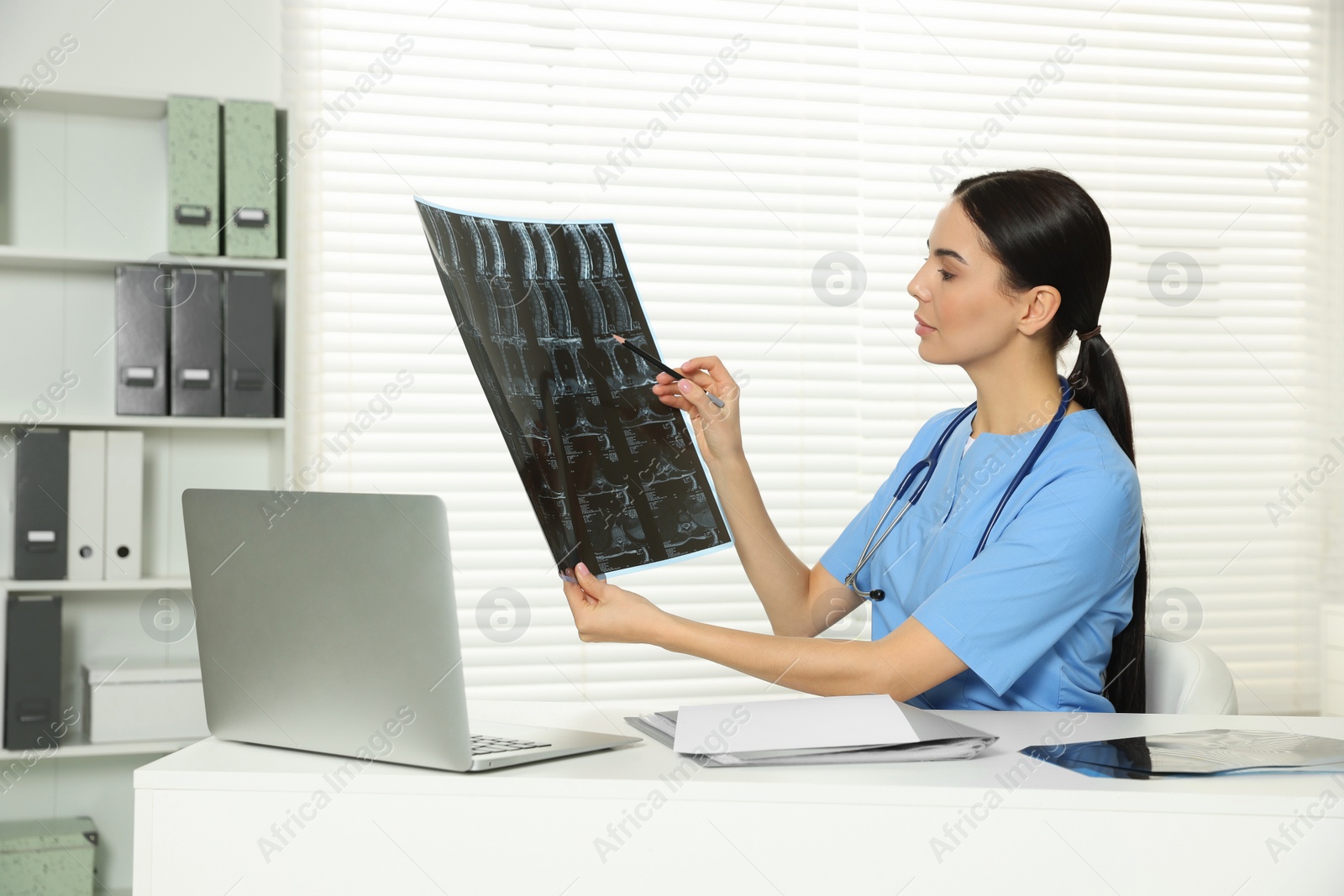 Photo of Doctor examining neck MRI image in clinic