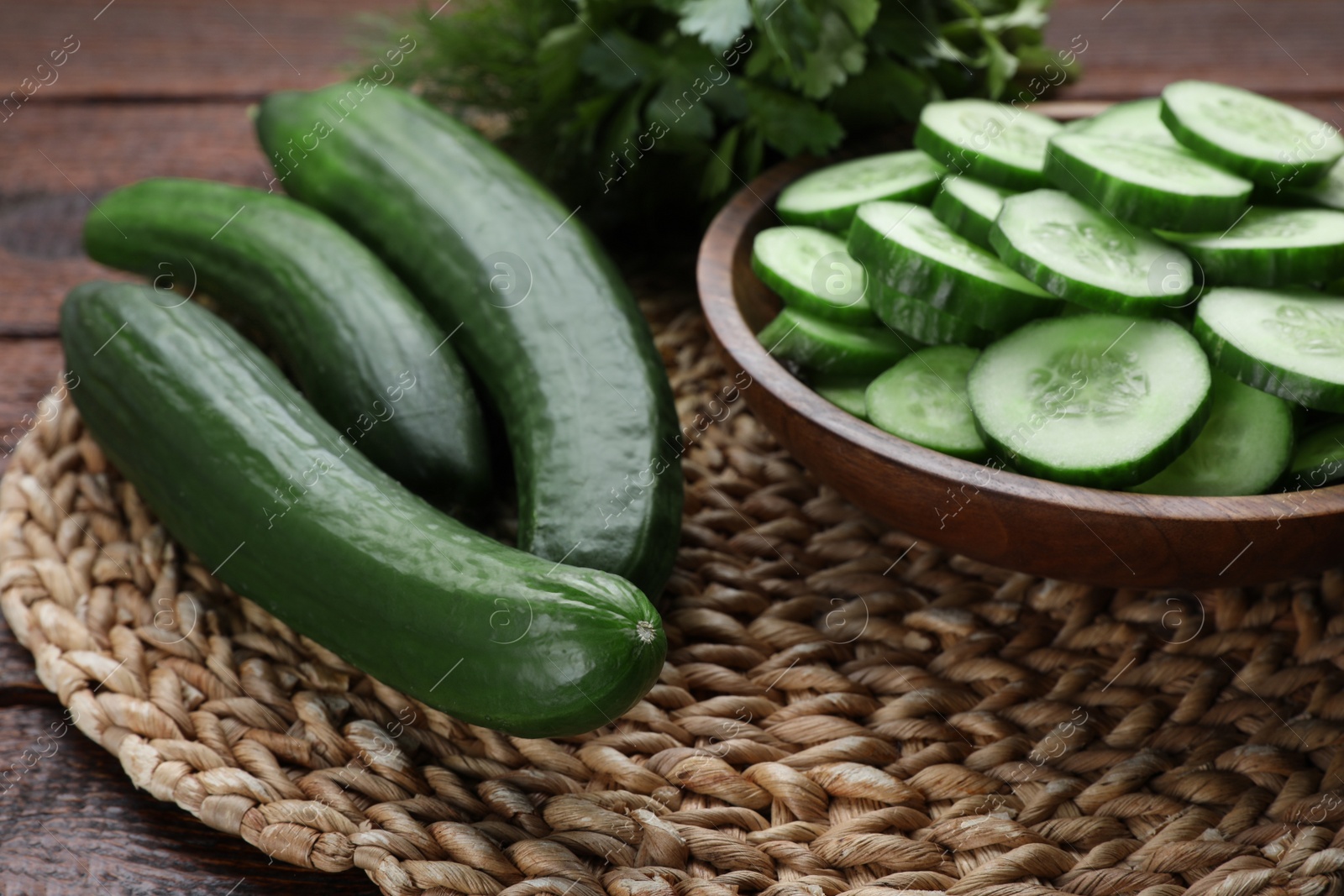 Photo of Fresh ripe cucumbers on wooden table, closeup