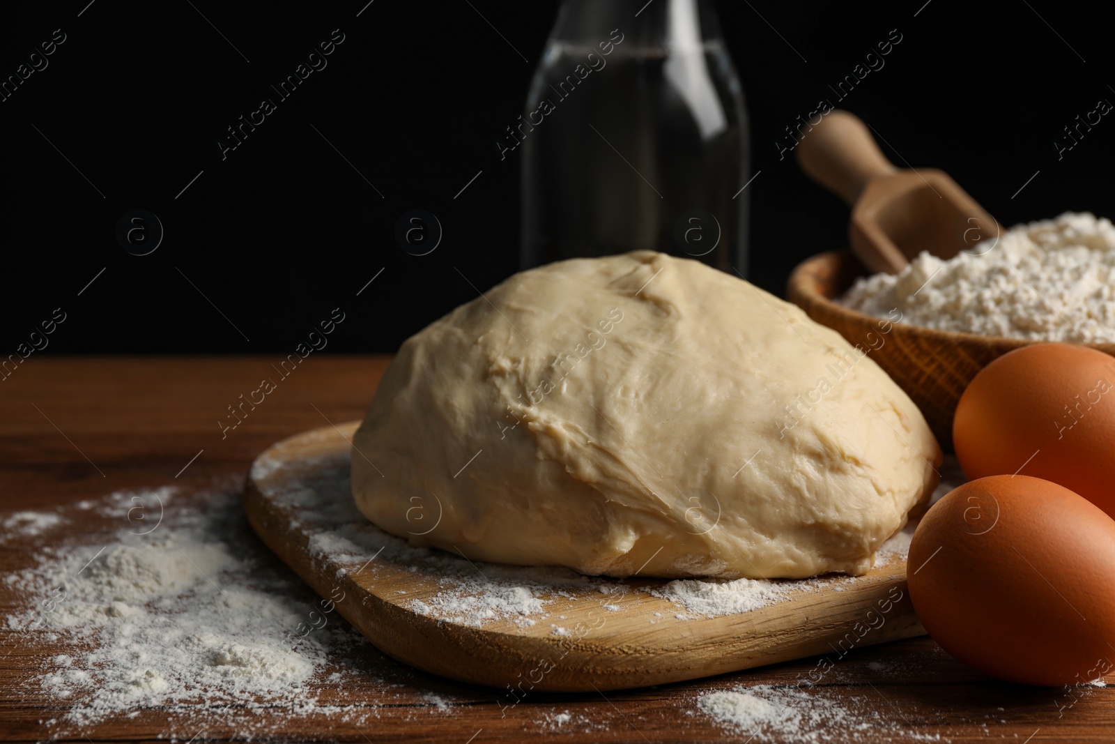 Photo of Cooking scones with soda water. Dough and ingredients on wooden table, closeup