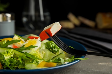 Photo of Delicious salad with crab sticks and lettuce on table, closeup