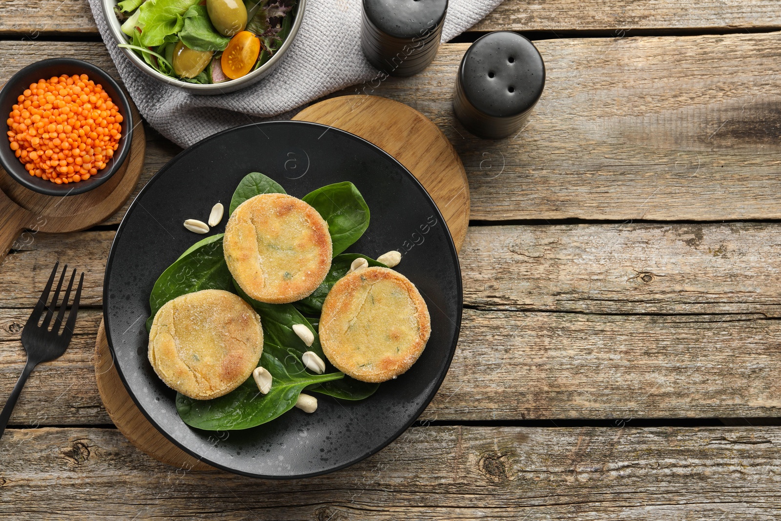 Photo of Healthy food high in vegetable fats and spices on wooden table, flat lay. Space for text