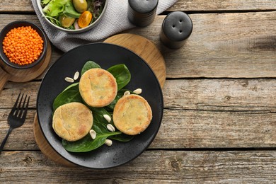 Photo of Healthy food high in vegetable fats and spices on wooden table, flat lay. Space for text