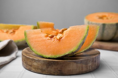 Tasty colorful ripe melons on white table, closeup